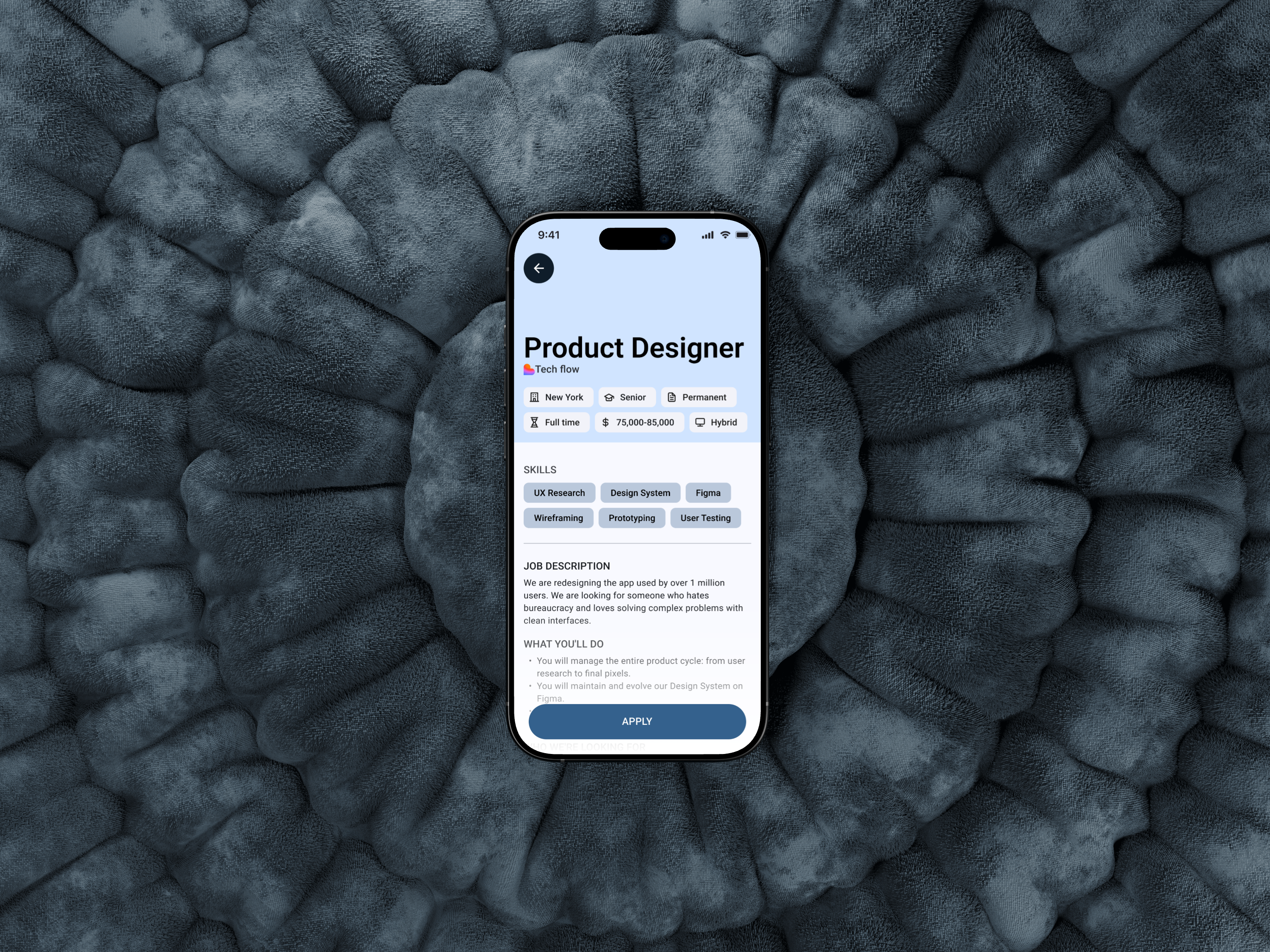 A hand holding a smartphone. On the screen, there is a landing page displaying a phrase against fast fashion and an image of a sweater.