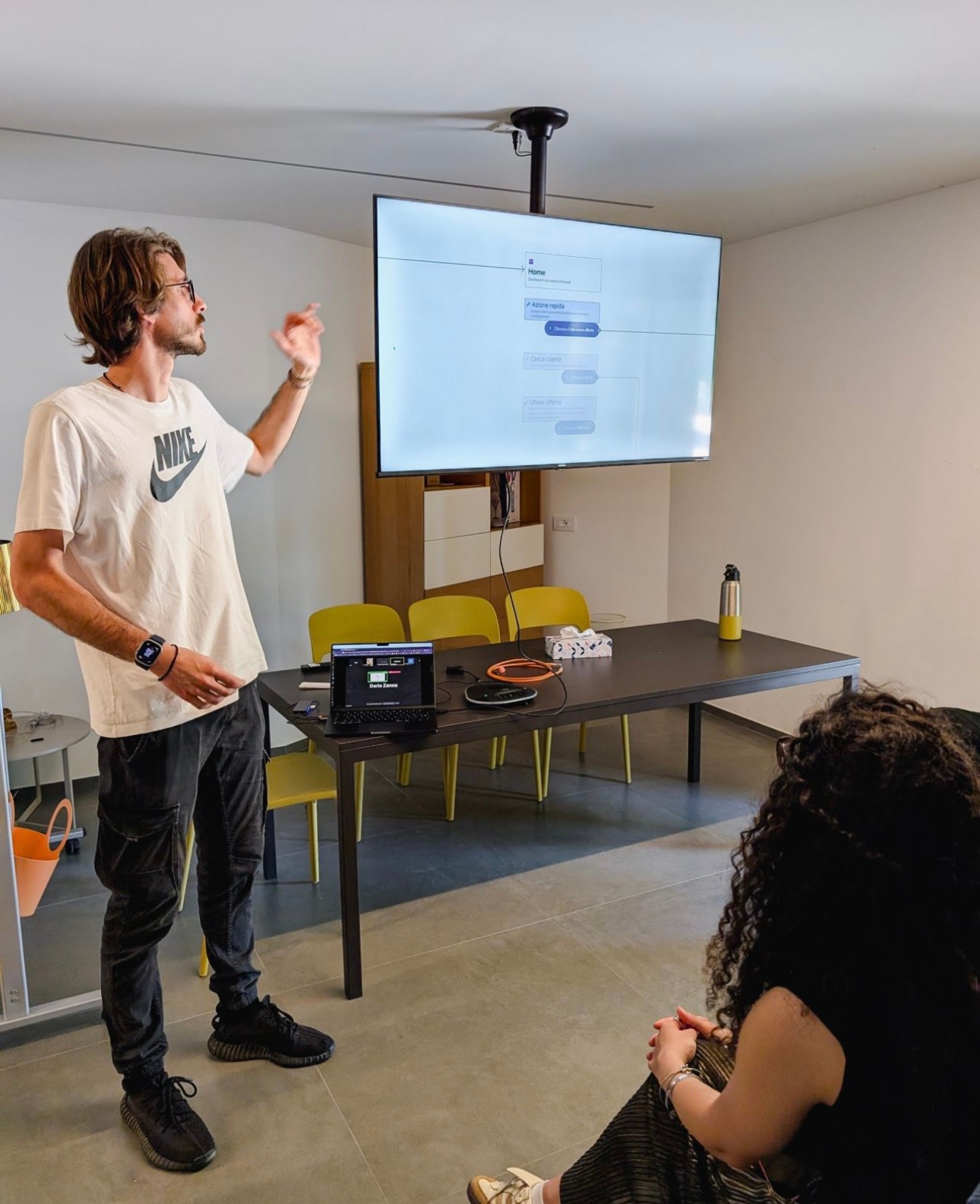 A boy standing and presenting a project on a screen.